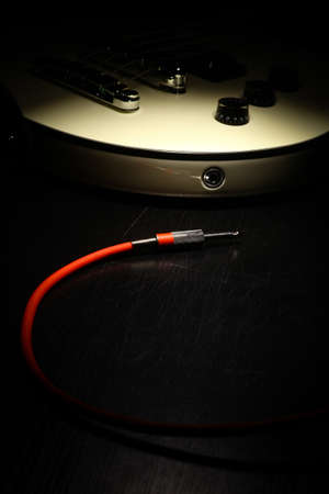 Detail on an electrical guitar and a red cord