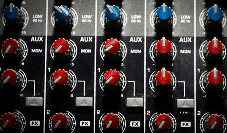 Detail of a music mixer desk with various knobs