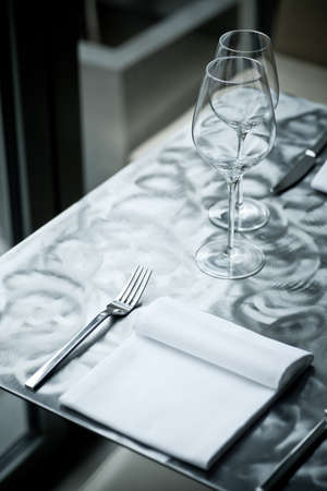 Fine restaurant dinner table place setting with napkin and wineglass の写真素材