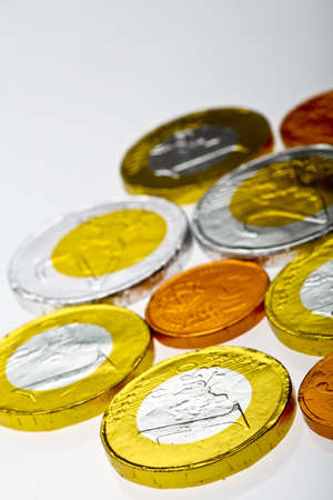 Chocolate sweets imitating various Euro coins, on white.の写真素材