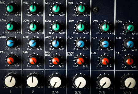 Detail of a music mixer desk with various knobs