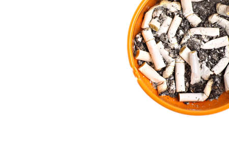 Detail of an orange ashtray with many burnt cigarettes.の写真素材
