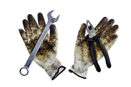 Two dirty gloves, a wrench, pliers, on whiteの写真素材