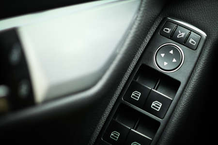 Detail on buttons controlling the windows in a car