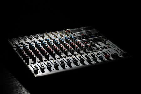 Bucharest, Romania - January 19, 2013: Detail of a Behringer music mixer desk with various knobs. Behringer is a German audio equipment company founded in 1989.のeditorial素材