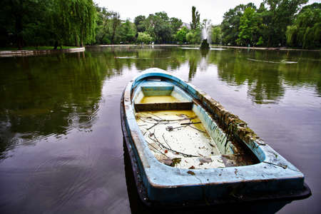 An abandoned boat on the shores of a lake