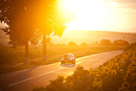 Bucharest, Romania - July 3, 2013: A BMW M3 car drives through a beautiful scenery, at sunset. The BMW M3 is a high-performance version of the BMW 3-Series, developed by BMW's motorsport division, BMW M.のeditorial素材