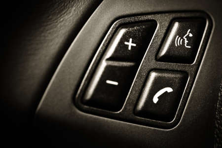 Detail on some buttons on a car's steering wheelの写真素材