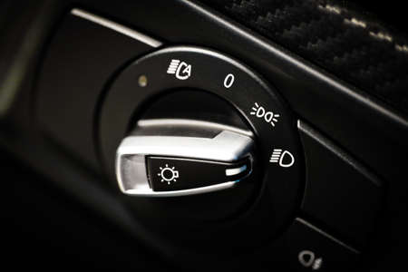 Detail of the headlight button in a carの写真素材