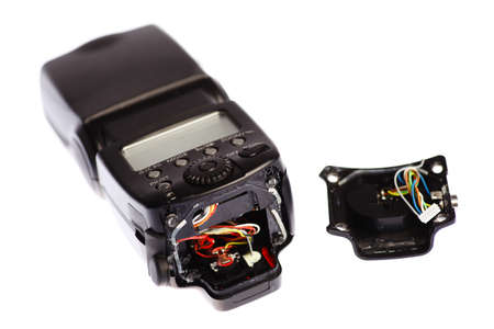 Picture of a broken external photo camera flash isolated on whiteの写真素材