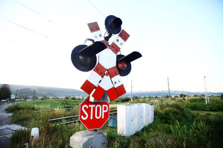 A stop sign at a railway crossingの写真素材