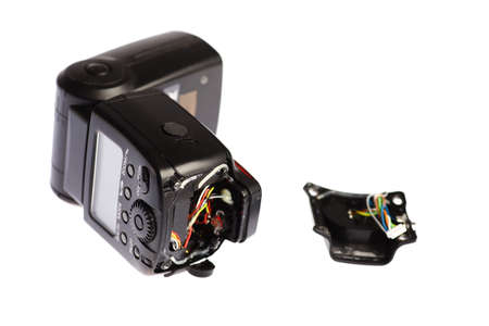 Picture of a broken external photo camera flash isolated on whiteの写真素材