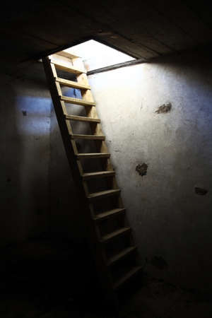 An old ladder in an underground roomの写真素材