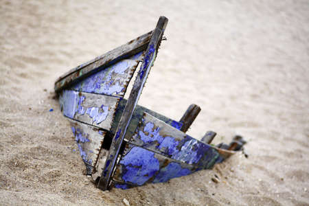 Color picture of an abandoned boat stuck in sandの写真素材
