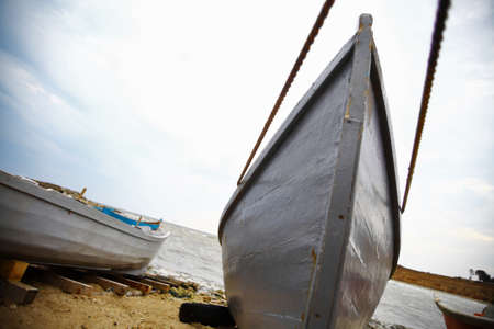 Some boats at the seashore on a cloudy dayの写真素材