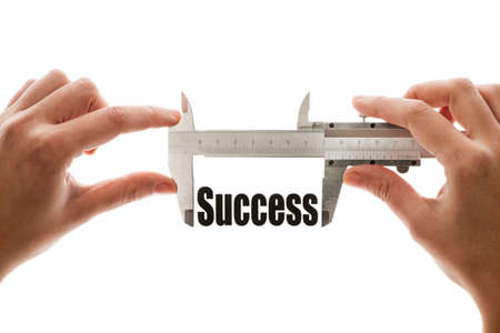 Close up shot of a caliper measuring the word  Success の写真素材