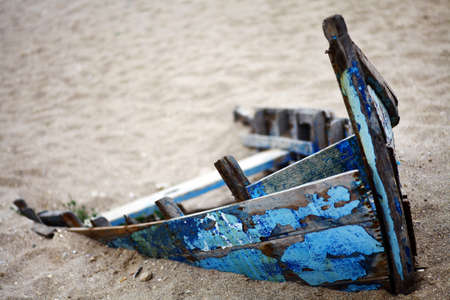 Color picture of an abandoned boat stuck in sandの写真素材