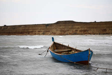 Some boats at the seashore on a cloudy dayの写真素材