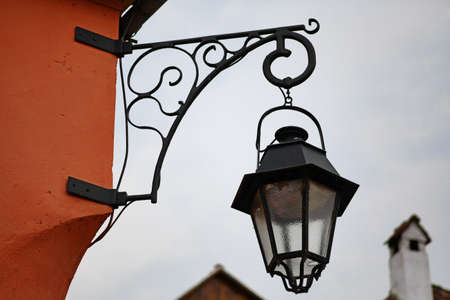 Vintage street lamp hanging on a wallの写真素材