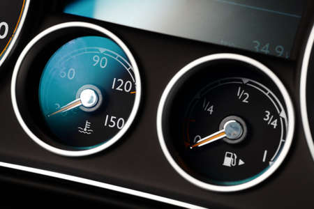 Coolant temperature and fuel level gauges on a car's dashboard