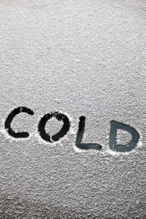 The word "cold" is written in the snowの写真素材