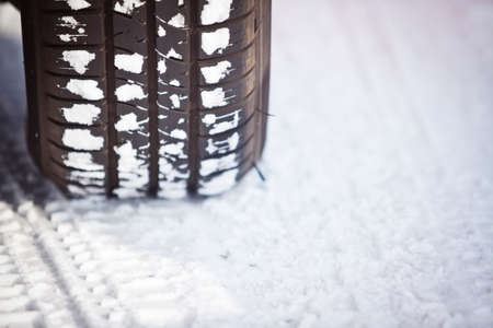 Close up shot of a car's tire in snowの写真素材