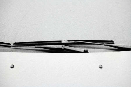 Close-up shot of a car's windscreen wiper covered in snowの写真素材