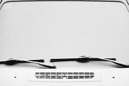 Close-up shot of a car's winsdcreen wiper covered in snowの写真素材