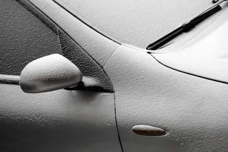 Close-up shot of a car covered in snow