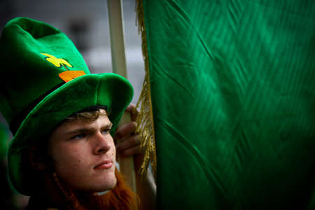 Bucharest, Romania - March 16, 2014: A man holds a green flag during a parade celebrating Saint Patrick's day in Bucharest, Romania.  Saint Patrick is the patron saint of Ireland and credited with bringing Christianity to Ireland.
のeditorial素材