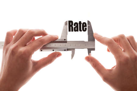 Close up shot of a caliper measuring the word Rate