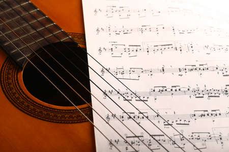 A classical guitar and a music sheet.の写真素材