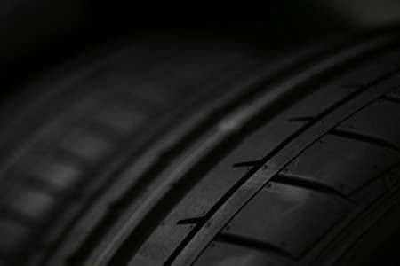Detail of a car tire, on black.の写真素材