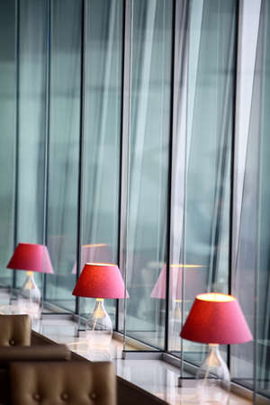 Interior with some lamps and tall windows.の写真素材
