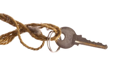 Close up shot of a used key isolated on white.の写真素材