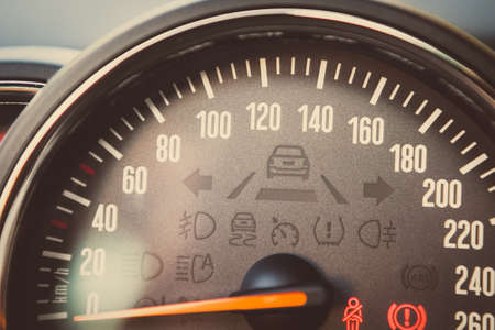 Close up shot of a speedometer in a car.