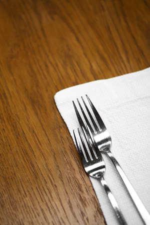 Two forks on a dinner table in a restaurant.の写真素材