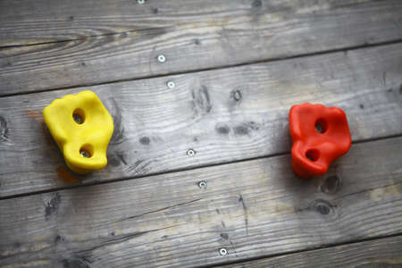 Detail of a climbing wall with some colored holds.の写真素材