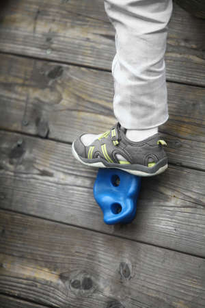 Detail of a climbing wall with some colored holds.