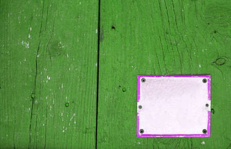 Color shot of an empty white sign on a green wall.の写真素材