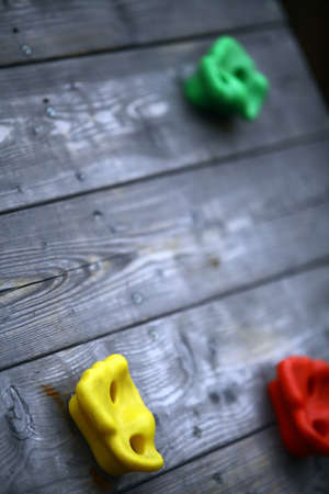 Detail of a climbing wall with some colored holds.の写真素材
