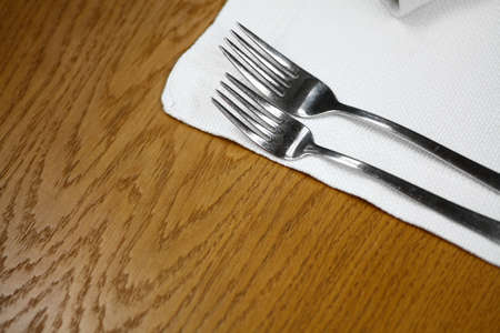 Two forks on a dinner table in a restaurant.の写真素材