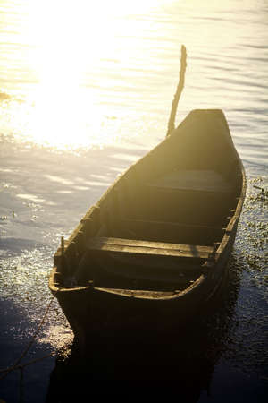 Color picture of a wooden boat on a river bank.の写真素材
