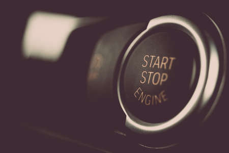Detail on a black start button in a car.
