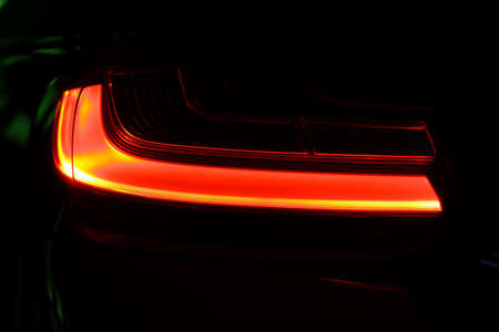 Detail on the rear light of a red car.の写真素材