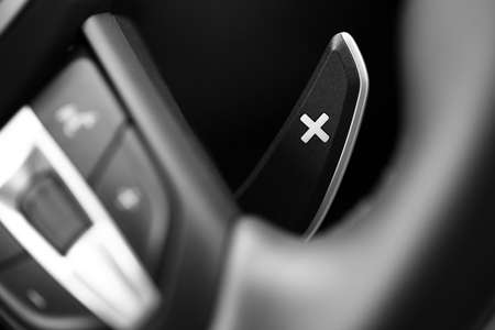 Close up shot of a manual gear changing paddle on a car's steering wheel.の写真素材