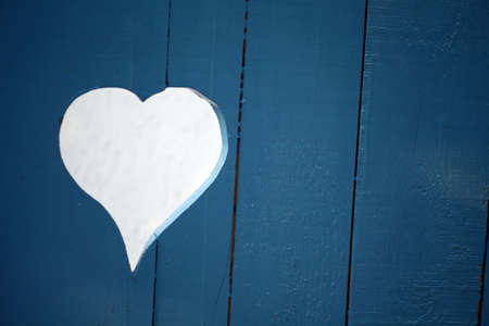Color picture of a heart-shaped hole in a some wood planks.の写真素材