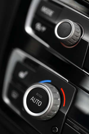 Color detail with the air conditioning button inside a car.