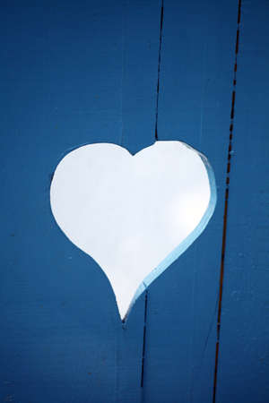 Color picture of a heart-shaped hole in a some wood planks.の写真素材