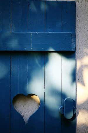 Color picture of a heart-shaped hole in a some wood planks.の写真素材